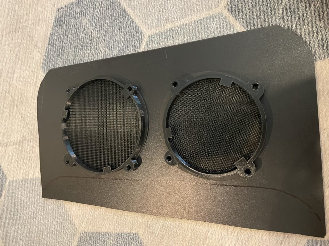 Overland Rig HVAC Window Mounting 3 a black speaker with two round holes