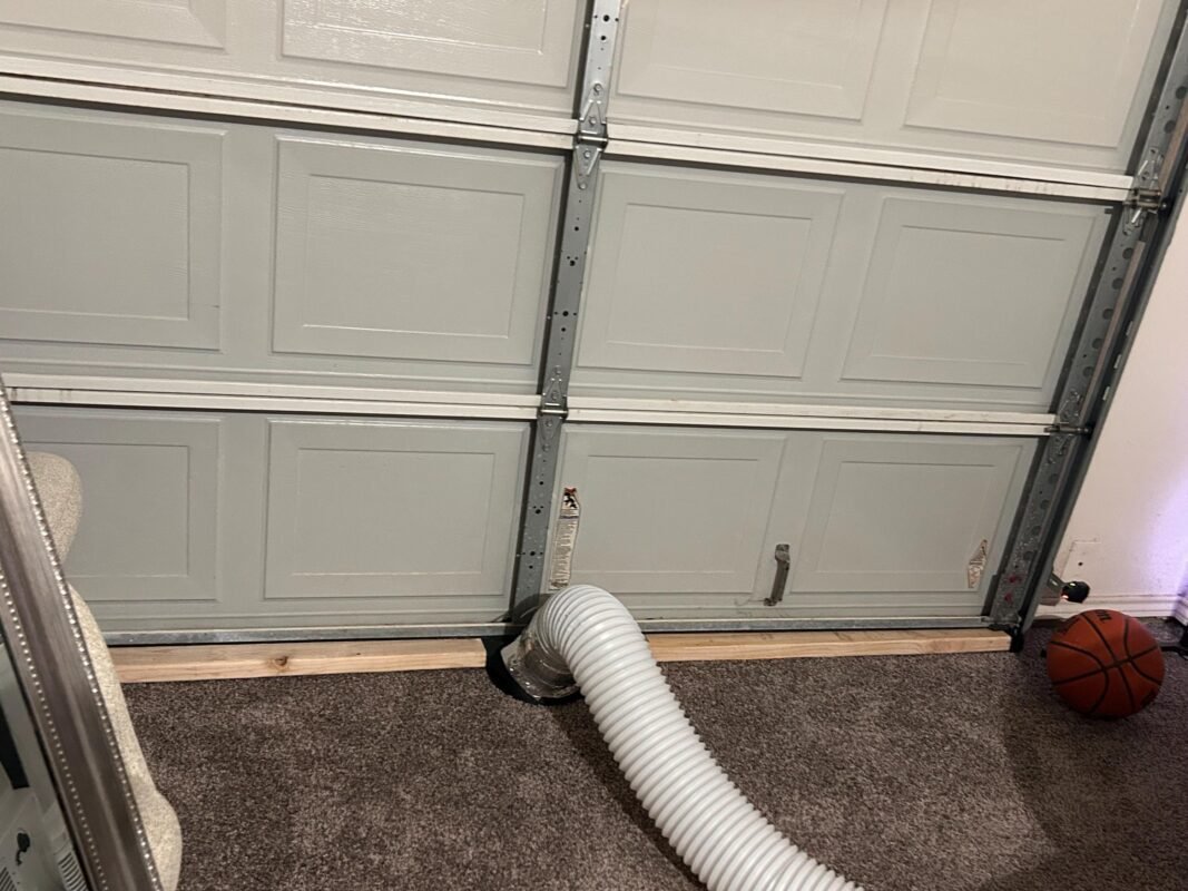 Under Garage Door 2x4 Seal Exhaust Smoke Laser Duct Shroud Review by Amber 2 a white hose coming out of a garage door