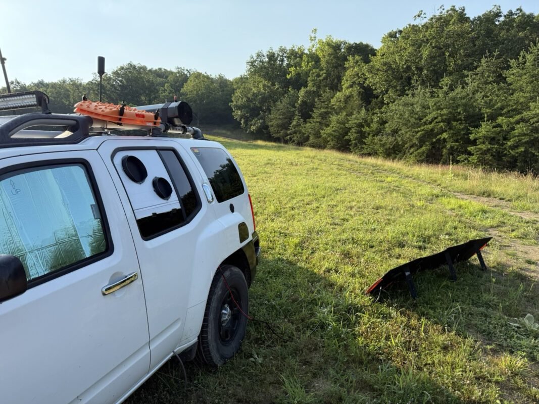 EcoFlow Wave Mounted in an Xterra SUV DIY Window Kit 3 a white car parked in a grassy field